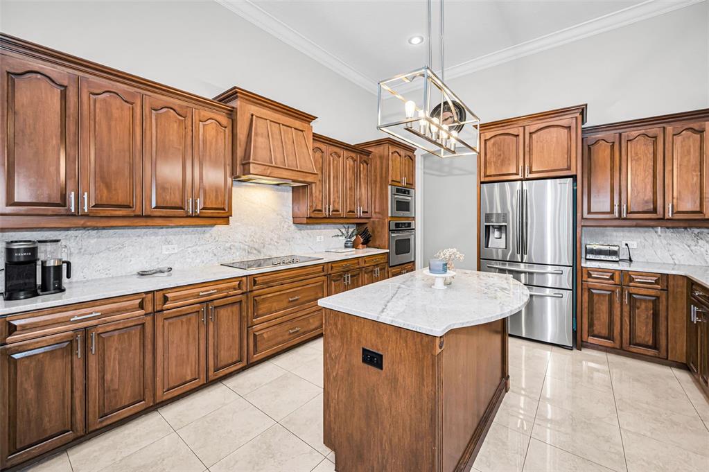 10709 Watula Court New Port Richey, FL 34655 - Photo 23 of 99 a kitchen with stainless steel appliances granite countertop a sink stove and refrigerator