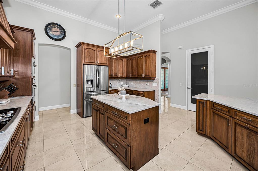 10709 Watula Court New Port Richey, FL 34655 - Photo 24 of 99 a kitchen with stainless steel appliances granite countertop a stove a refrigerator and a sink