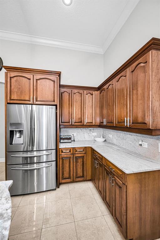 10709 Watula Court New Port Richey, FL 34655 - Photo 26 of 99 a kitchen with stainless steel appliances granite countertop a refrigerator and a sink