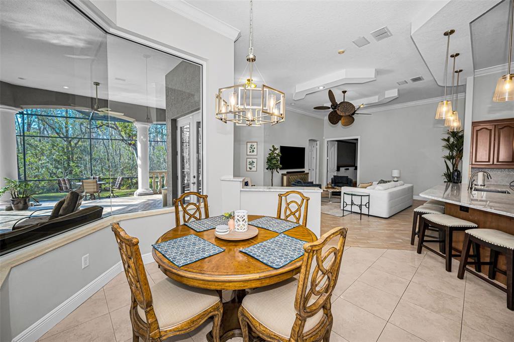 10709 Watula Court New Port Richey, FL 34655 - Photo 33 of 99 a view of a dining room with furniture window and outside view
