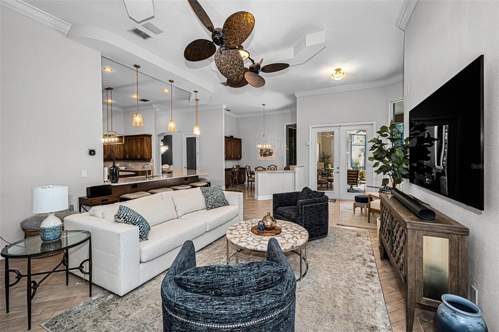 10709 Watula Court New Port Richey, FL 34655 - Photo 37 of 99 a living room with furniture a flat screen tv and a chandelier