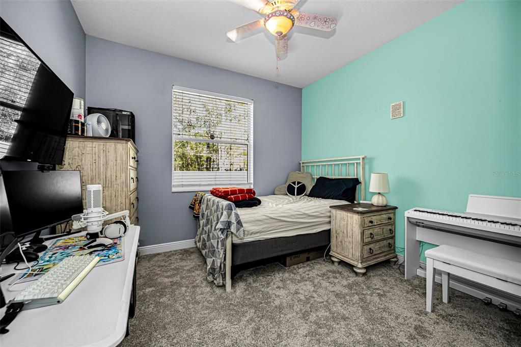 10709 Watula Court New Port Richey, FL 34655 - Photo 61 of 99 a bedroom with a bed and a flat screen tv