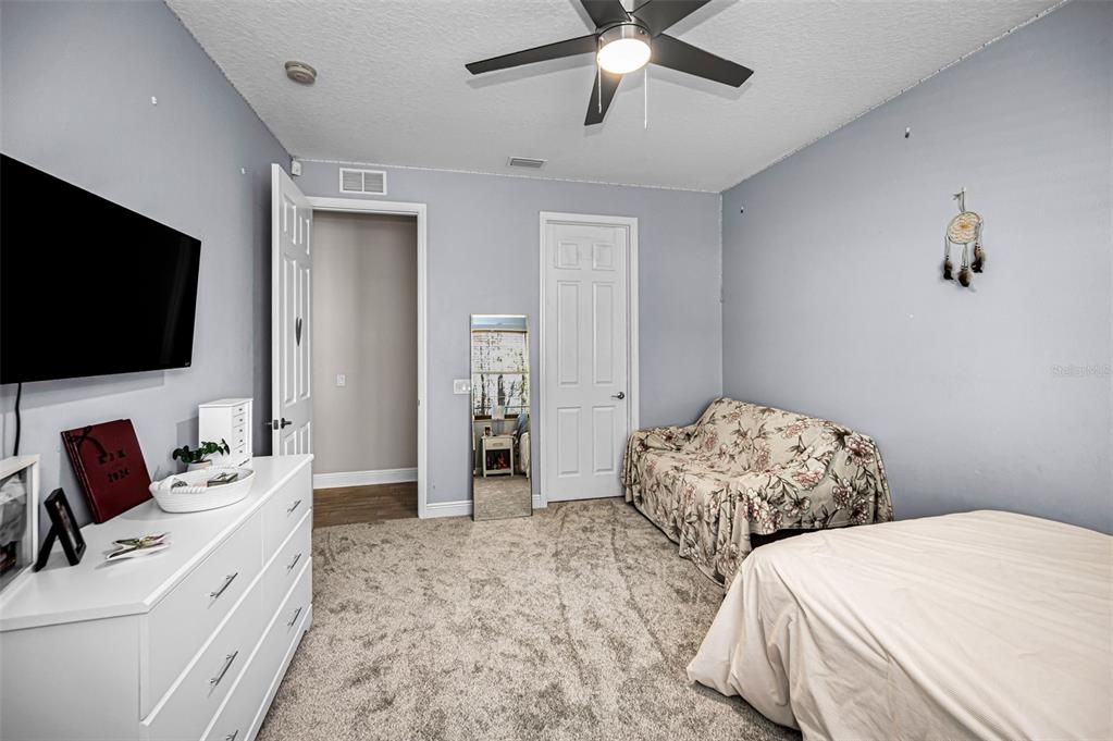 10709 Watula Court New Port Richey, FL 34655 - Photo 64 of 99 a bedroom with two bed and a flat screen tv