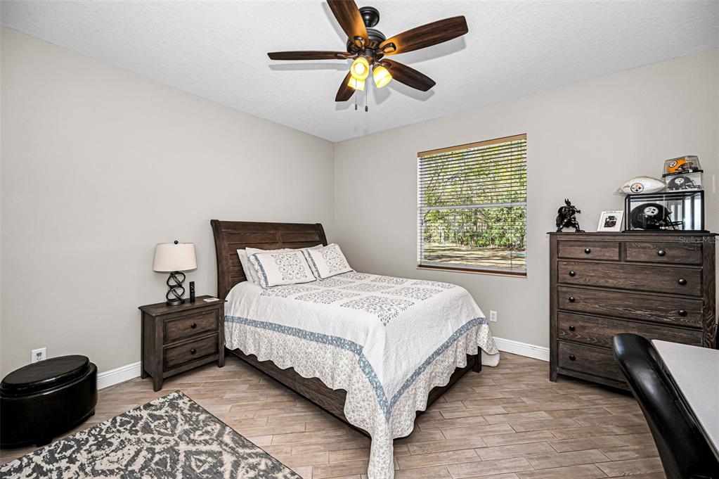 10709 Watula Court New Port Richey, FL 34655 - Photo 65 of 99 a bedroom with a bed and a closet