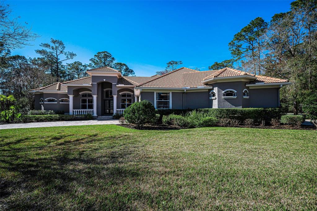 10709 Watula Court New Port Richey, FL 34655 - Photo 96 of 99 a front view of a house with a garden