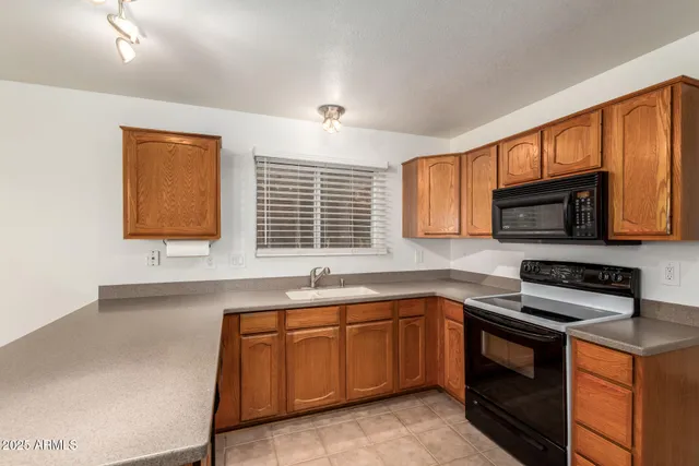 a kitchen with a sink stove and microwave