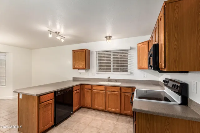a kitchen that has a sink and a stove in it