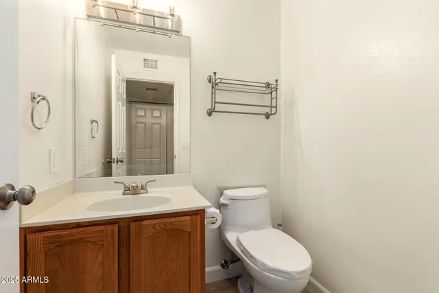 a bathroom with a sink mirror and toilet