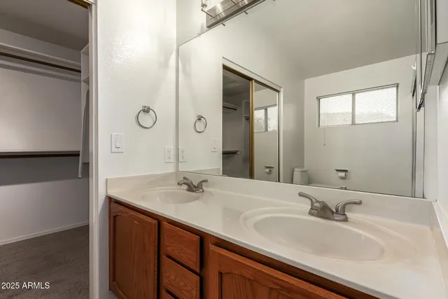 a bathroom with a double vanity sink and mirror