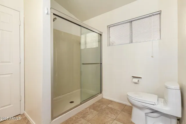 a bathroom with a shower and a toilet
