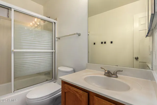 a bathroom with a sink toilet vanity and shower