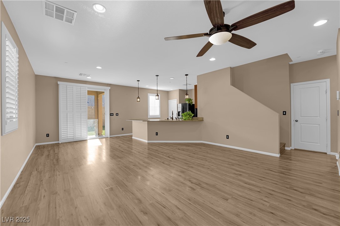 915 Harbor Avenue Henderson, NV 89002 - Photo 3 of 32 Unfurnished living room featuring a ceiling fan, light wood finished floors, and recessed lighting