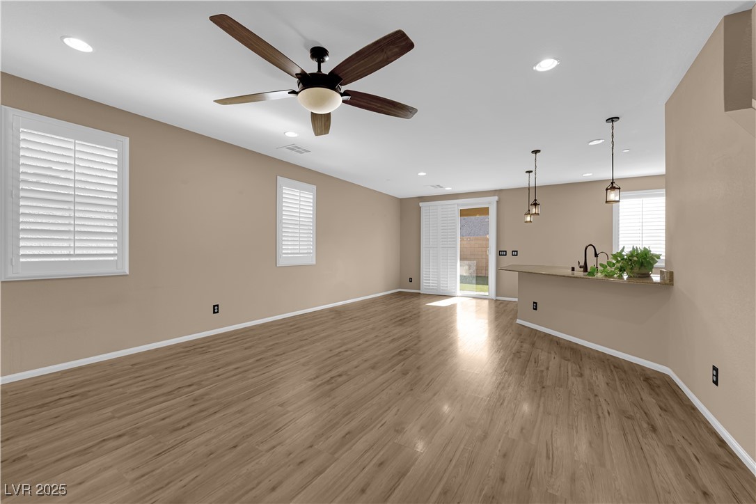 915 Harbor Avenue Henderson, NV 89002 - Photo 4 of 32 Unfurnished living room featuring wood finished floors, recessed lighting, and a ceiling fan