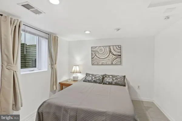 a bedroom with furniture and a rug