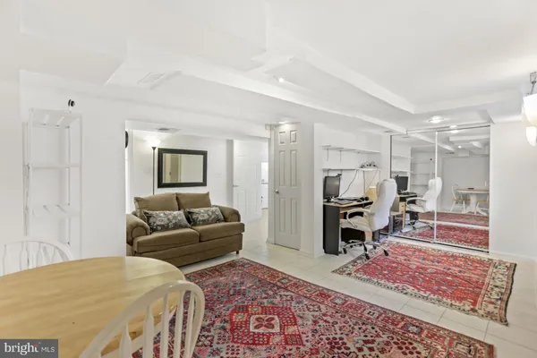 a living room with furniture rug and wooden floor