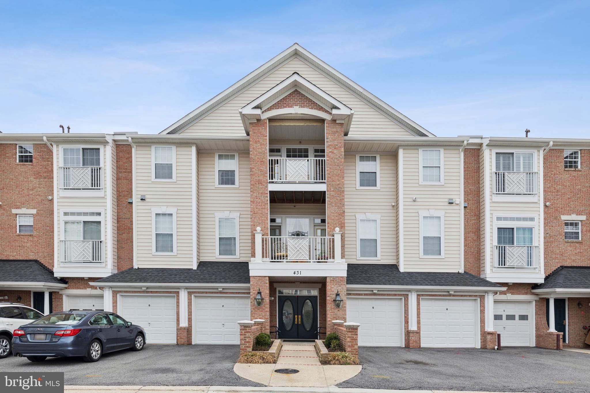 431 Hamlet Club Drive, Unit 102 Edgewater, MD 21037 - Photo 1 of 55 a front view of a residential apartment building with a yard