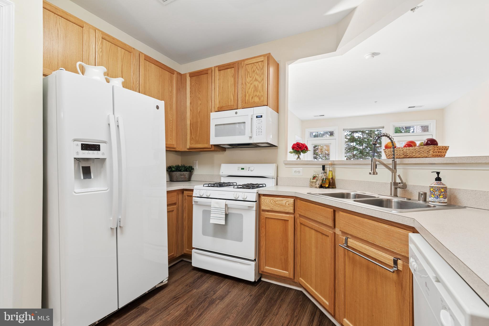 431 Hamlet Club Drive, Unit 102 Edgewater, MD 21037 - Photo 11 of 55 a kitchen with white cabinets and white appliances