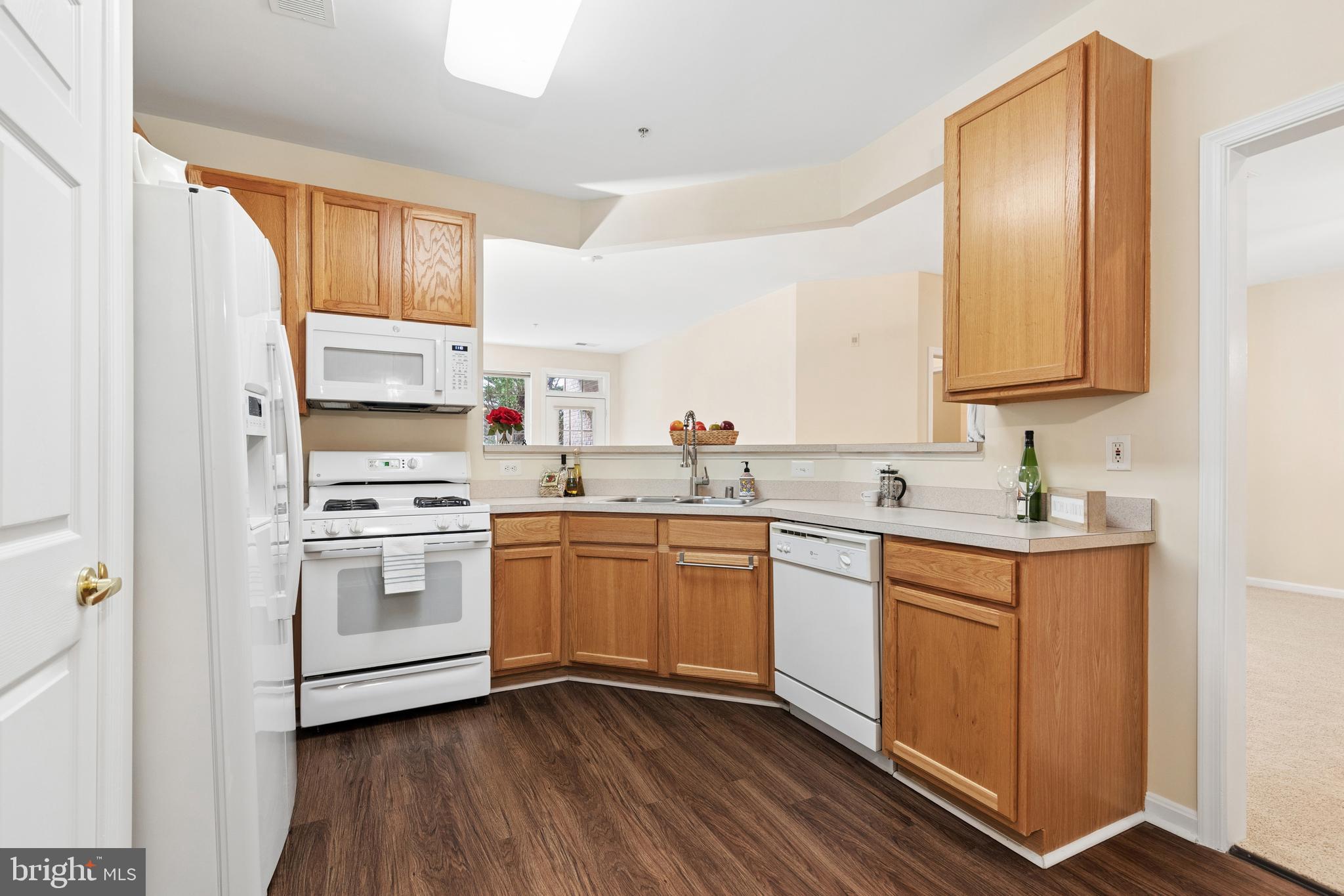 431 Hamlet Club Drive, Unit 102 Edgewater, MD 21037 - Photo 12 of 55 a kitchen with white cabinets sink and white appliances