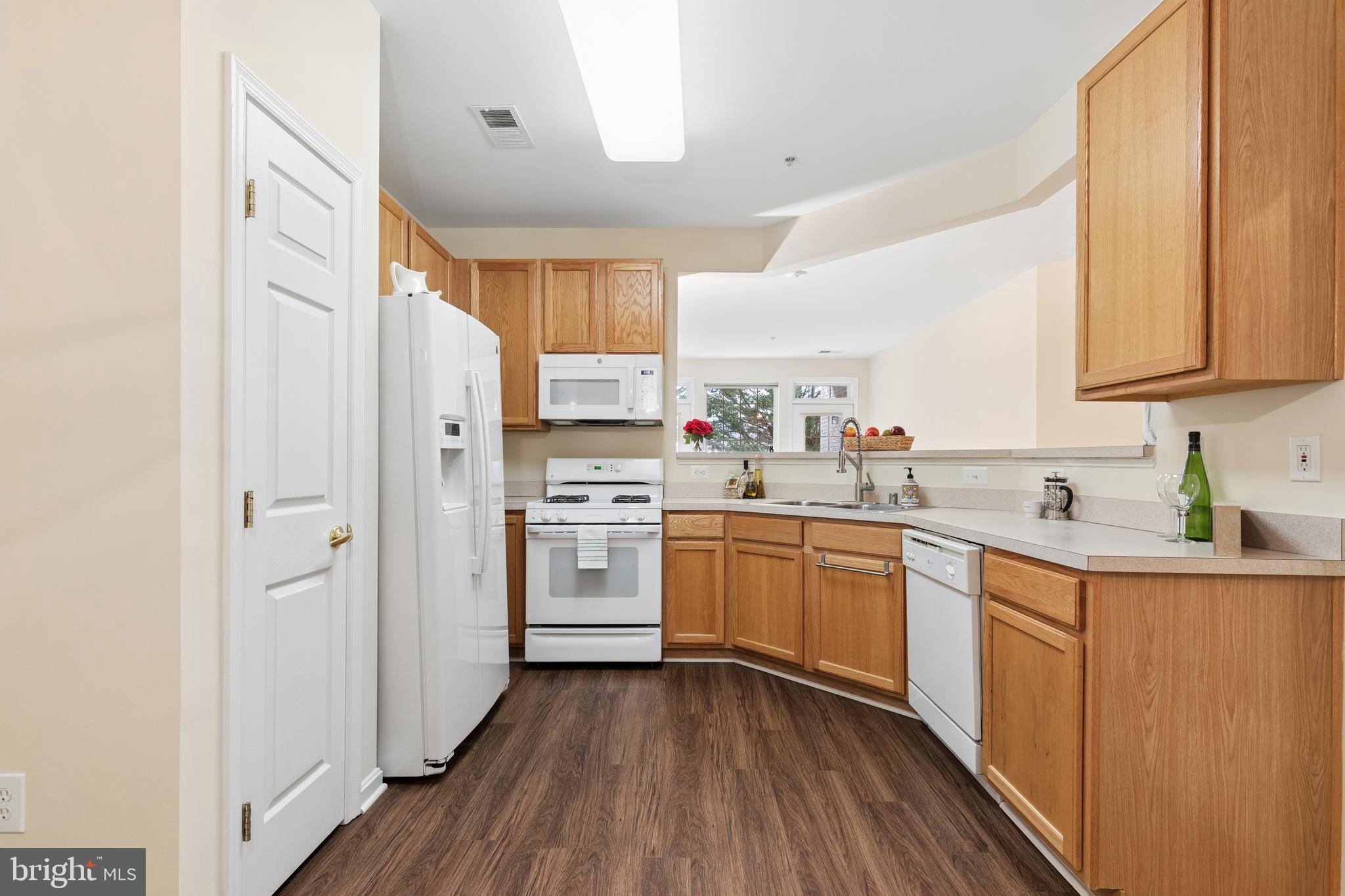 431 Hamlet Club Drive, Unit 102 Edgewater, MD 21037 - Photo 13 of 55 a kitchen with a sink cabinets stainless steel appliances and a window