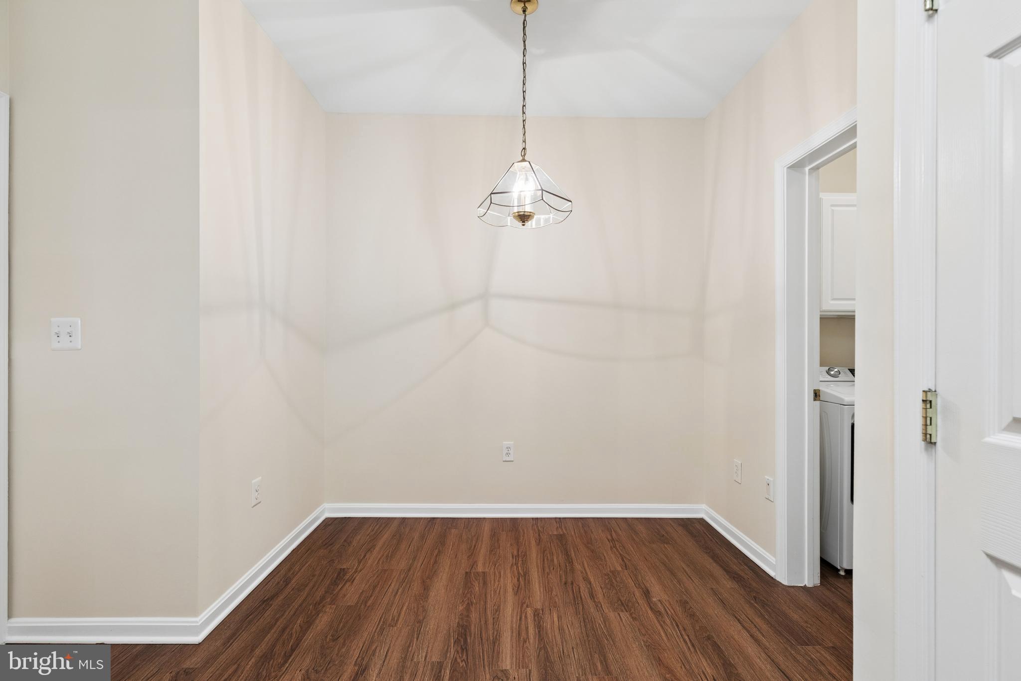 431 Hamlet Club Drive, Unit 102 Edgewater, MD 21037 - Photo 14 of 55 a view of a room with wooden floor and a ceiling fan