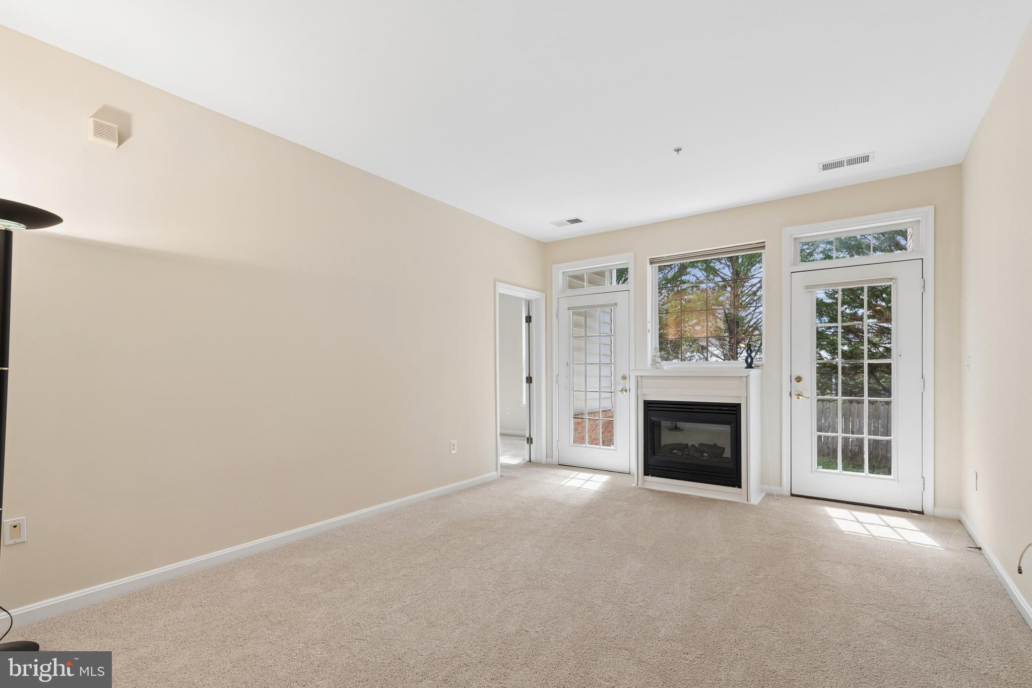 431 Hamlet Club Drive, Unit 102 Edgewater, MD 21037 - Photo 21 of 55 an empty room with windows and fireplace