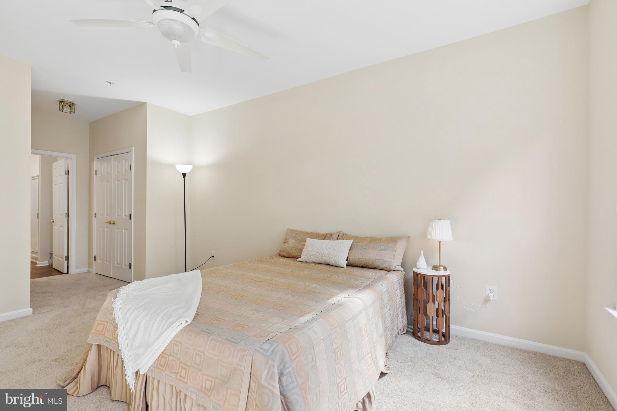 431 Hamlet Club Drive, Unit 102 Edgewater, MD 21037 - Photo 22 of 55 a bedroom with a bed and a ceiling fan