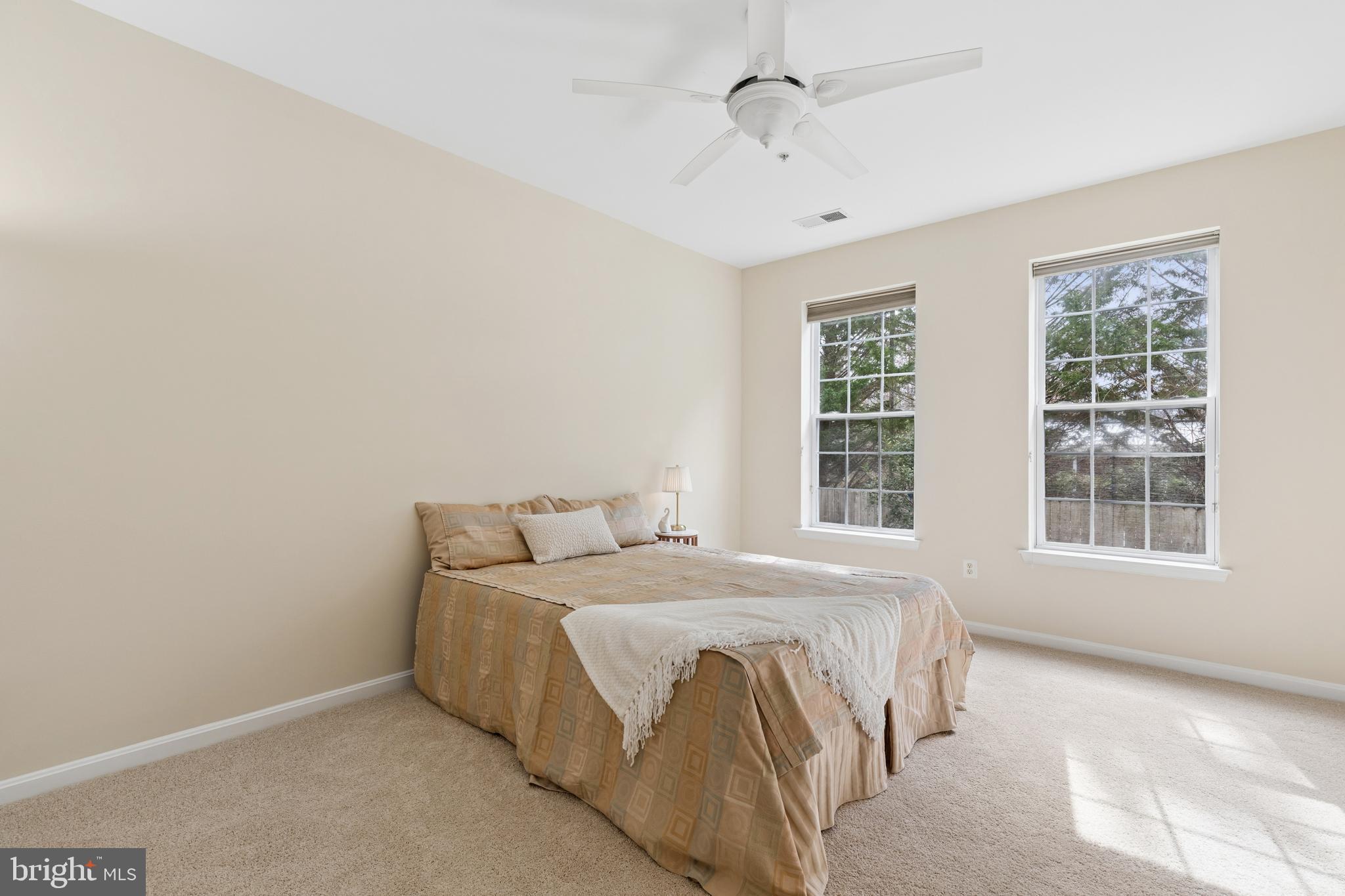 431 Hamlet Club Drive, Unit 102 Edgewater, MD 21037 - Photo 23 of 55 a bedroom with a bed and a window