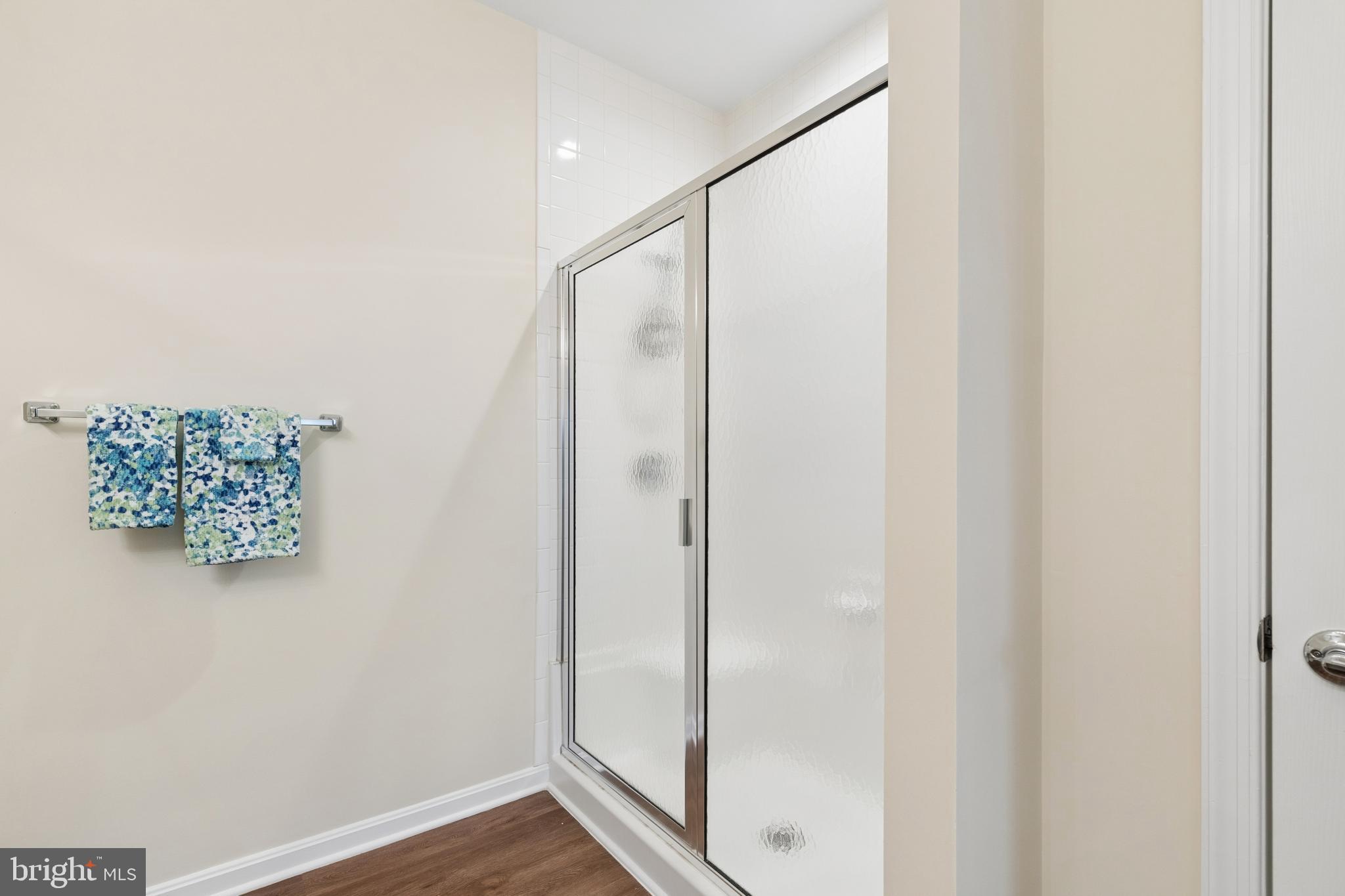 431 Hamlet Club Drive, Unit 102 Edgewater, MD 21037 - Photo 27 of 55 a bathroom with a shower and a glass door