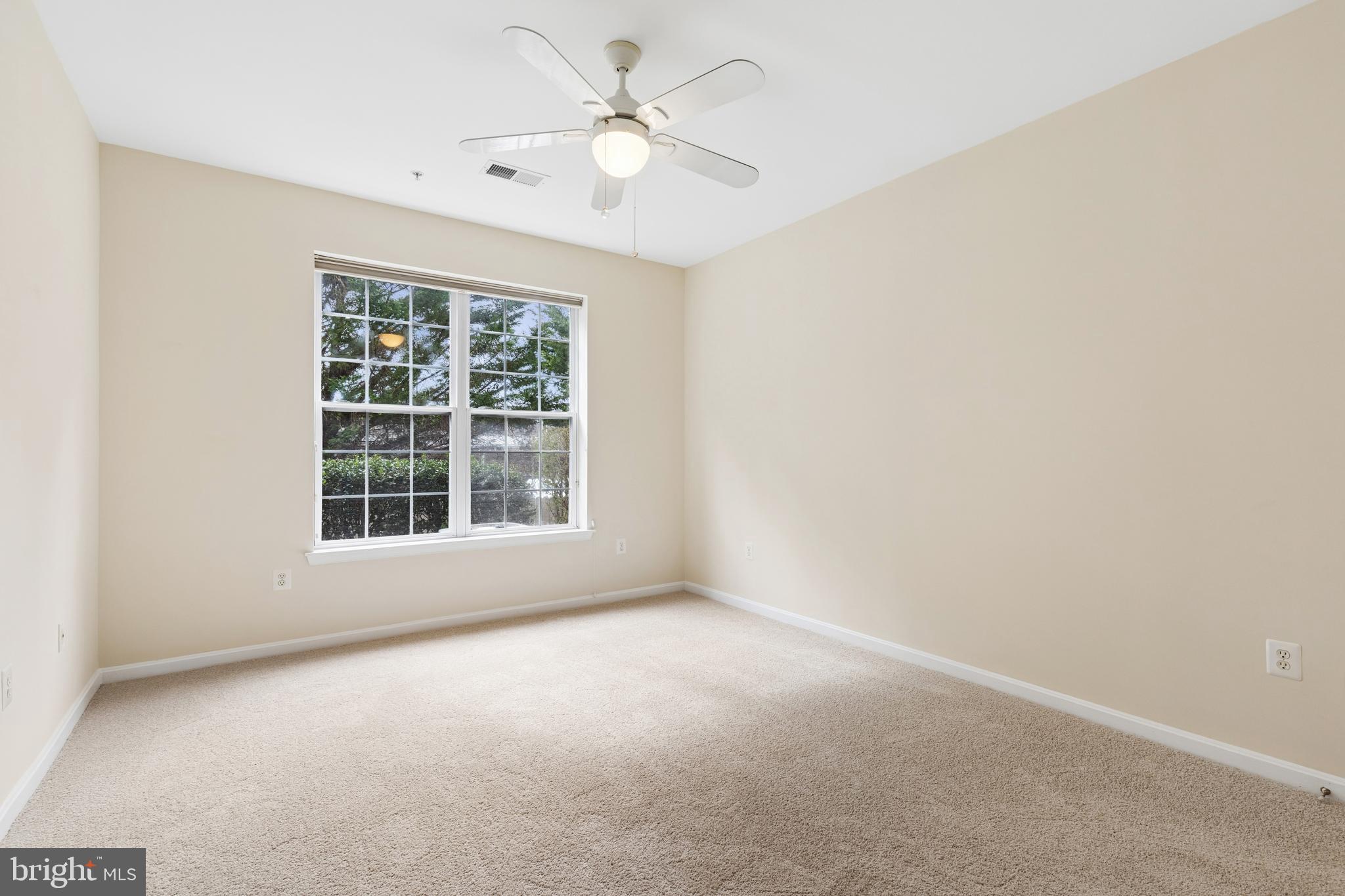 431 Hamlet Club Drive, Unit 102 Edgewater, MD 21037 - Photo 31 of 55 an empty room with a window and a fan
