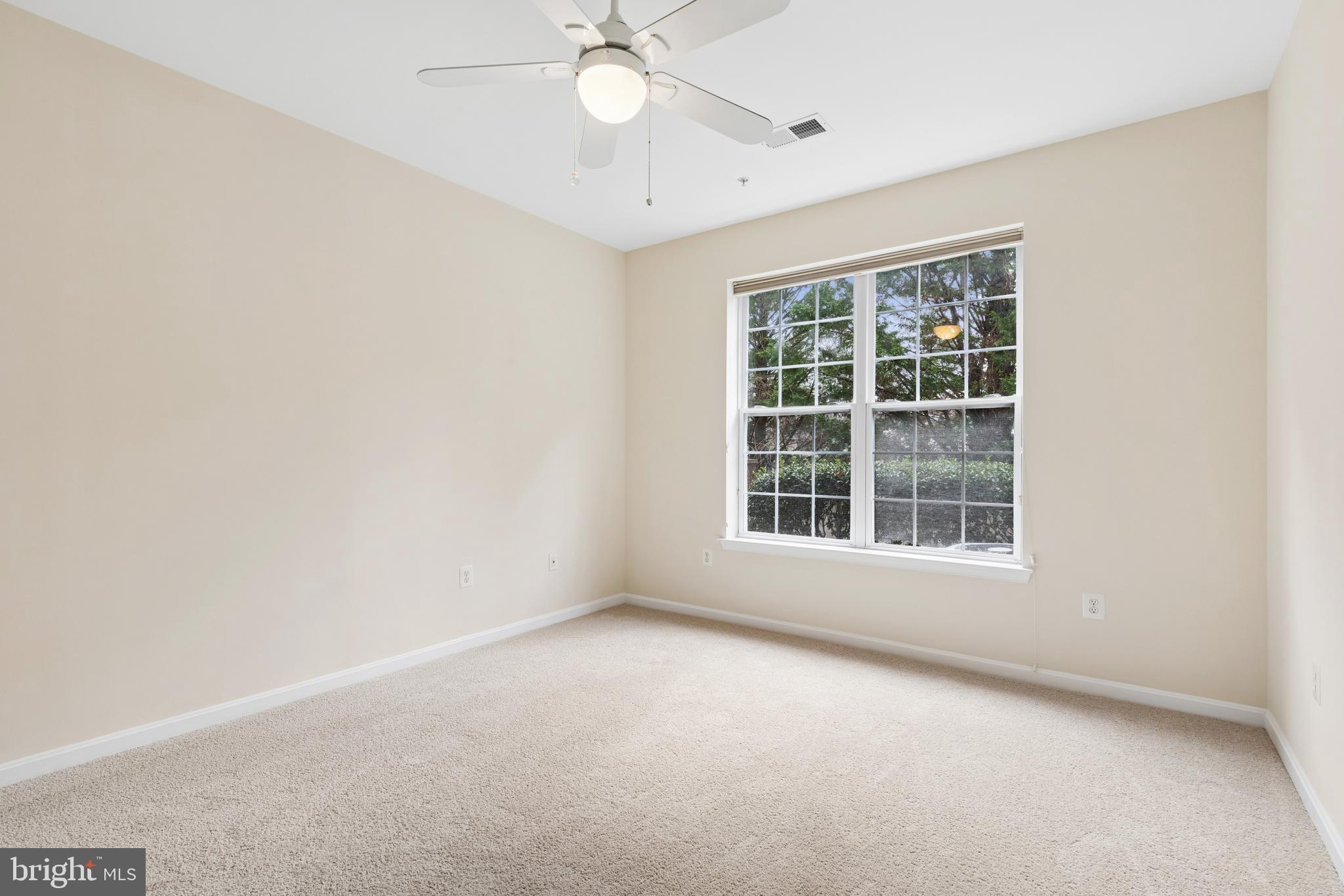431 Hamlet Club Drive, Unit 102 Edgewater, MD 21037 - Photo 32 of 55 an empty room with a window and a fan