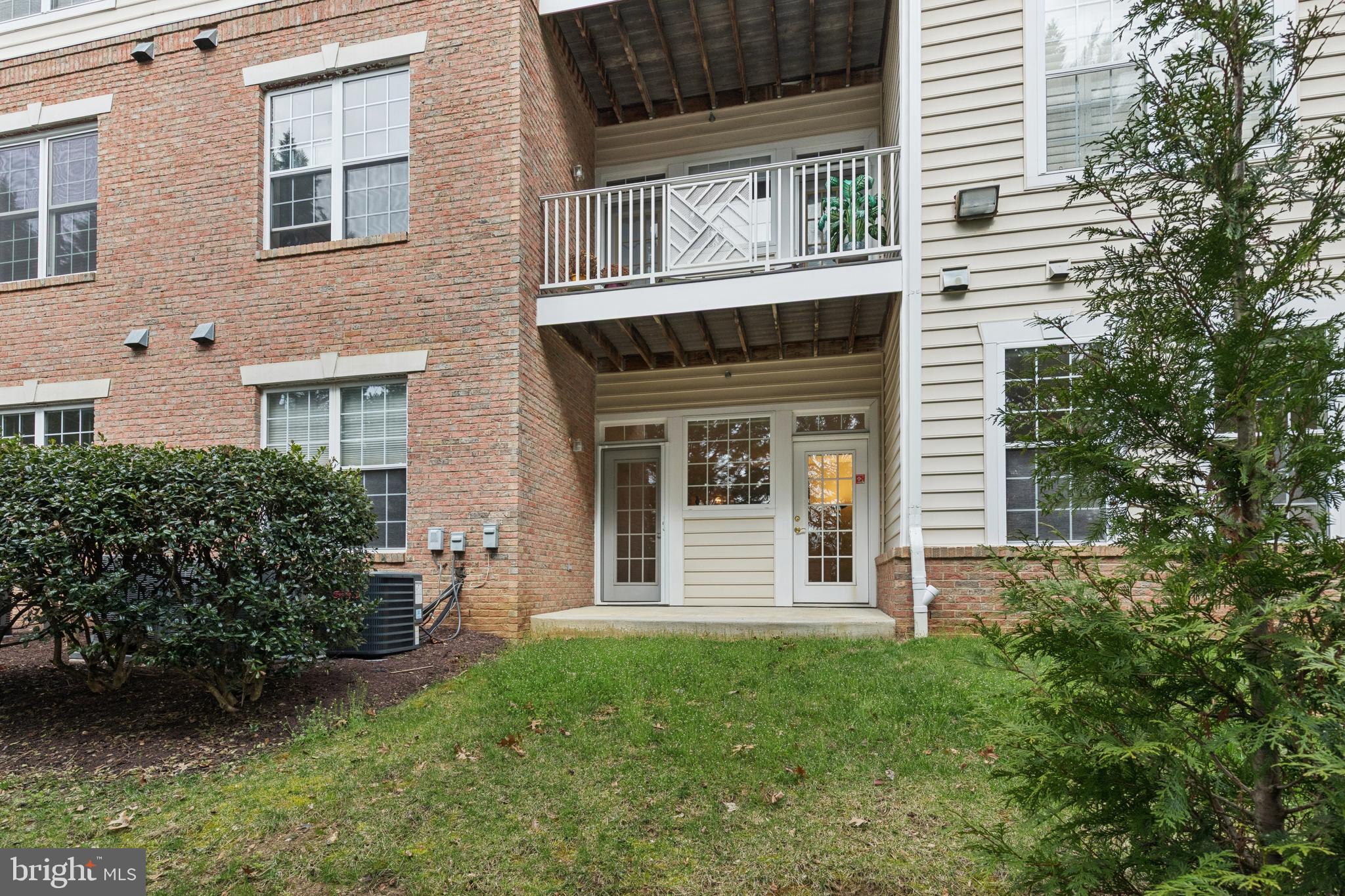 431 Hamlet Club Drive, Unit 102 Edgewater, MD 21037 - Photo 41 of 55 a view of a house with potted plants and a yard