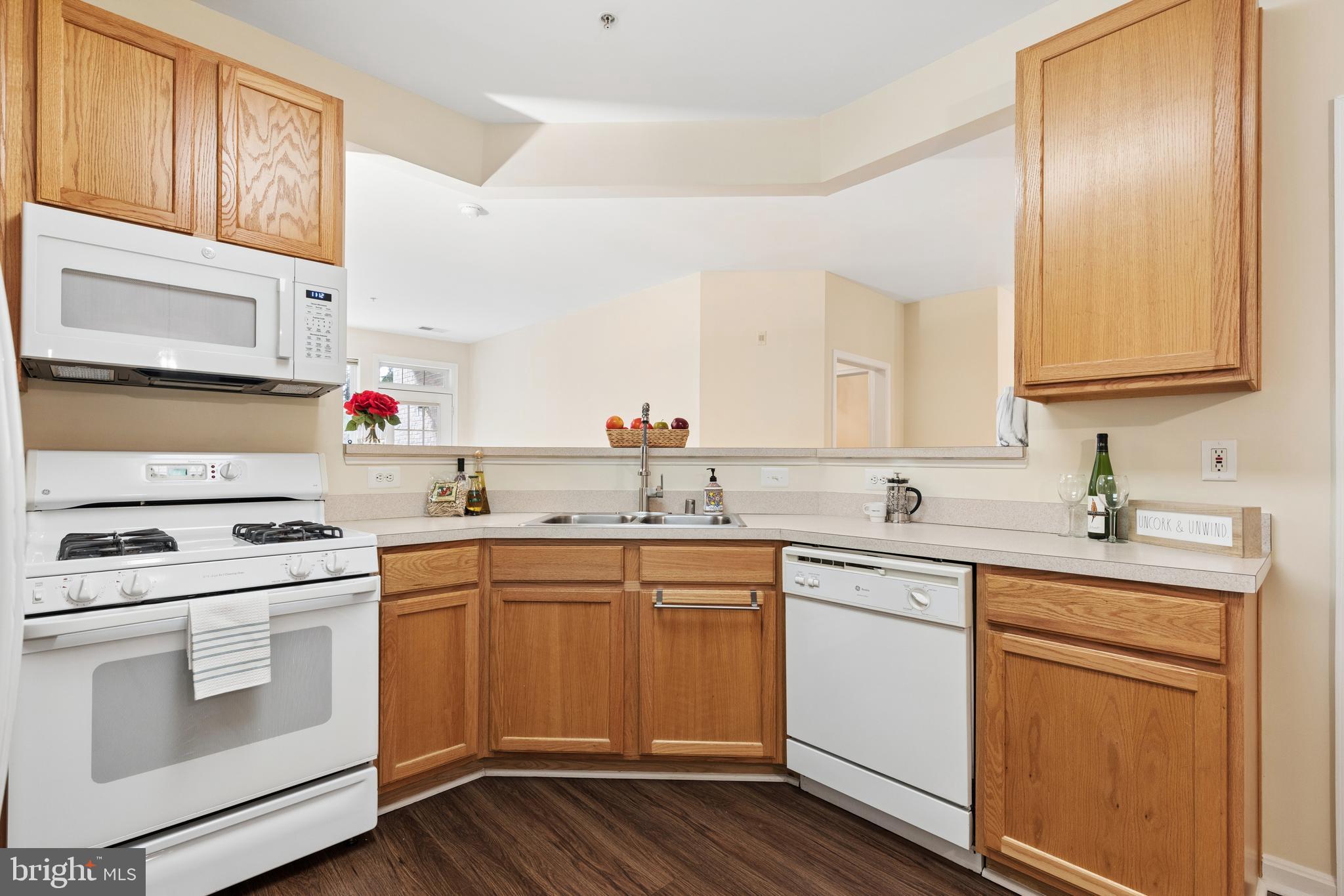 431 Hamlet Club Drive, Unit 102 Edgewater, MD 21037 - Photo 10 of 55 a kitchen with white cabinets sink and white appliances