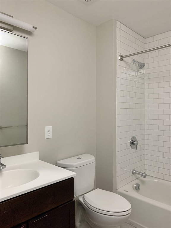 6 Chatham Street, Unit 103 Worcester, MA 01608 - Photo 4 of 6 a bathroom with a sink a toilet and shower