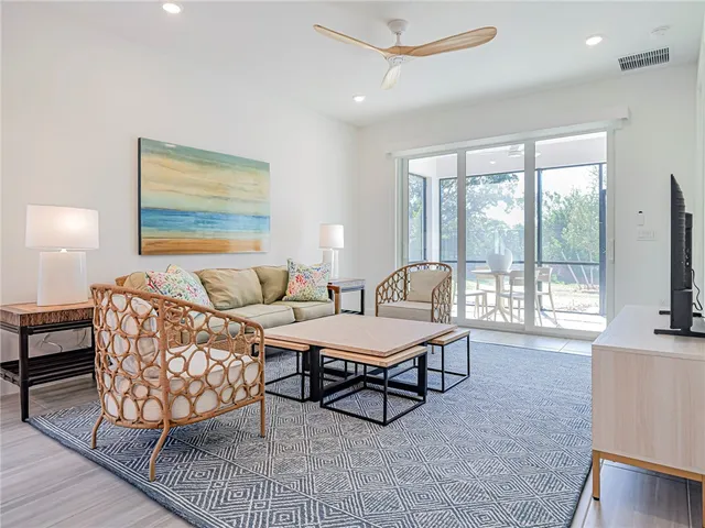 a kitchen with stainless steel appliances granite countertop a refrigerator a stove a sink and a microwave