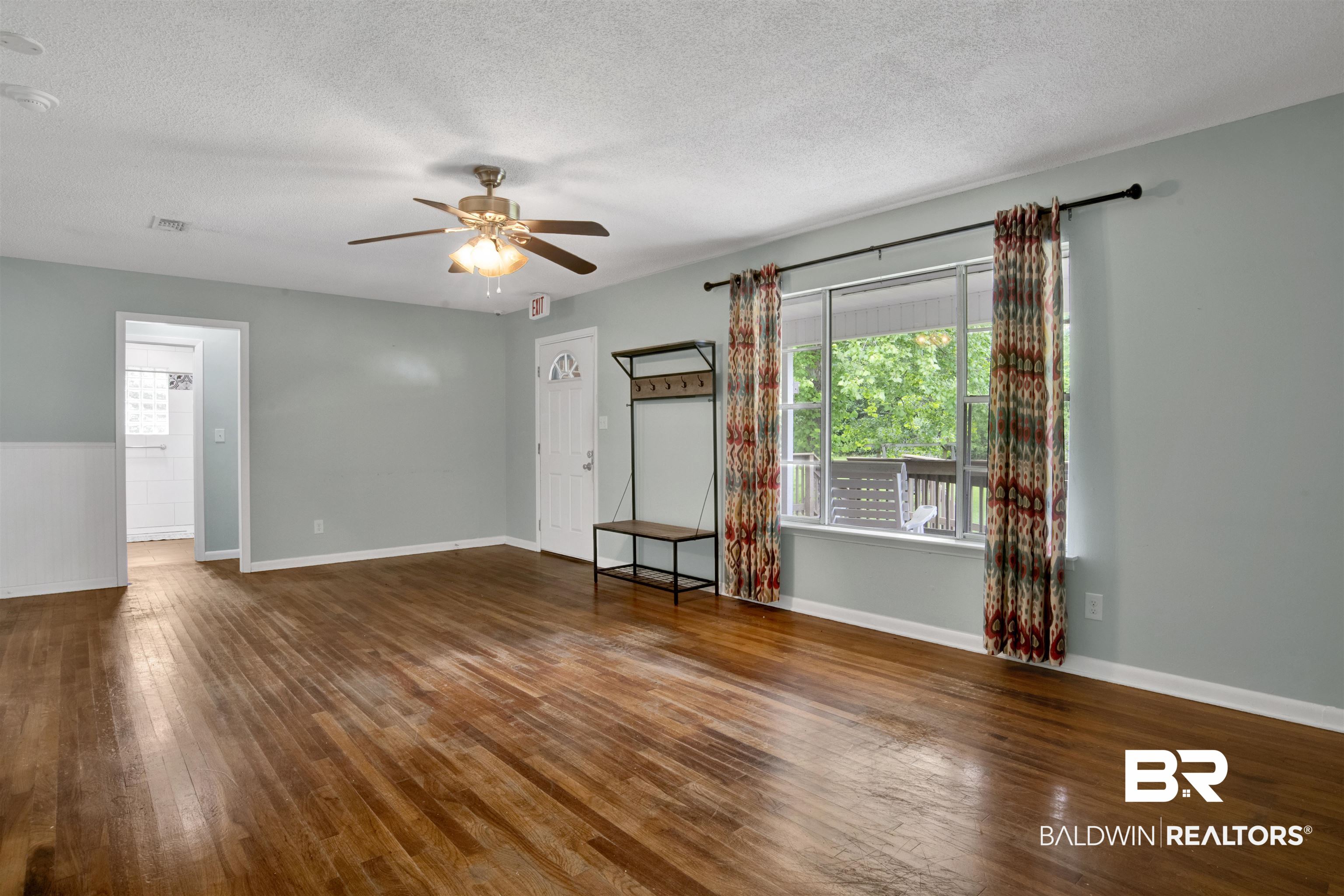 17714 Horseneck Road Bay Minette, AL 36507 - Photo 23 of 36 Spacious interior featuring wood-finish flooring, a ceiling fan with light fixture, and light blue wall paint
