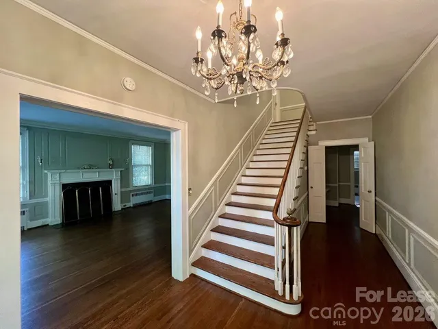 wooden floor with a chandelier and a dining table with wooden floor