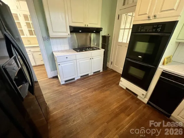 a kitchen with a sink and a stove top oven