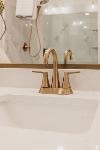 5902 Canyon Rim Road, Unit 620 Lehi, UT 84048 - Photo 74 of 78 White integrated sink with a brushed brass faucet, set within a light-toned countertop