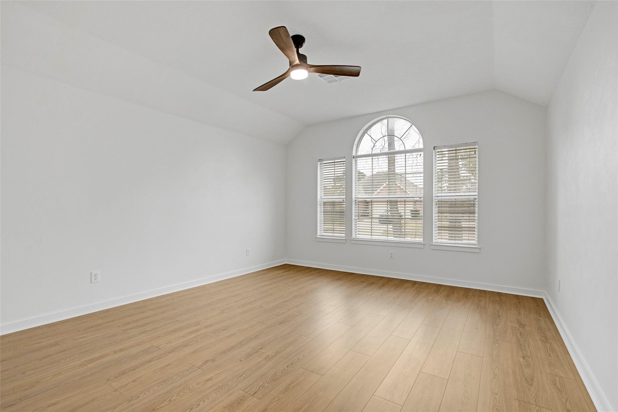 2414 Cres Hollow Court Spring, TX 77388 - Photo 27 of 37 an empty room with wooden floor fan and windows