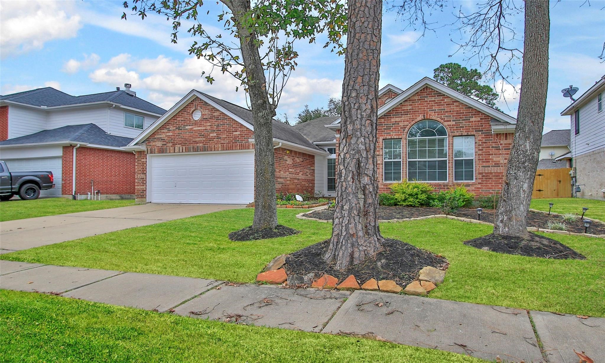 2414 Cres Hollow Court Spring, TX 77388 - Photo 3 of 37 a front view of a house with a yard and garage