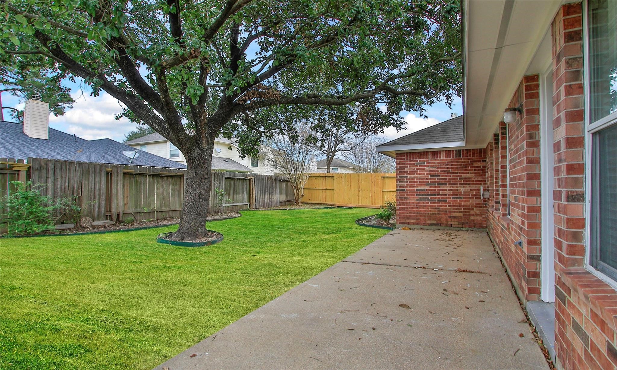 2414 Cres Hollow Court Spring, TX 77388 - Photo 33 of 37 a view of a yard with a tree and a table