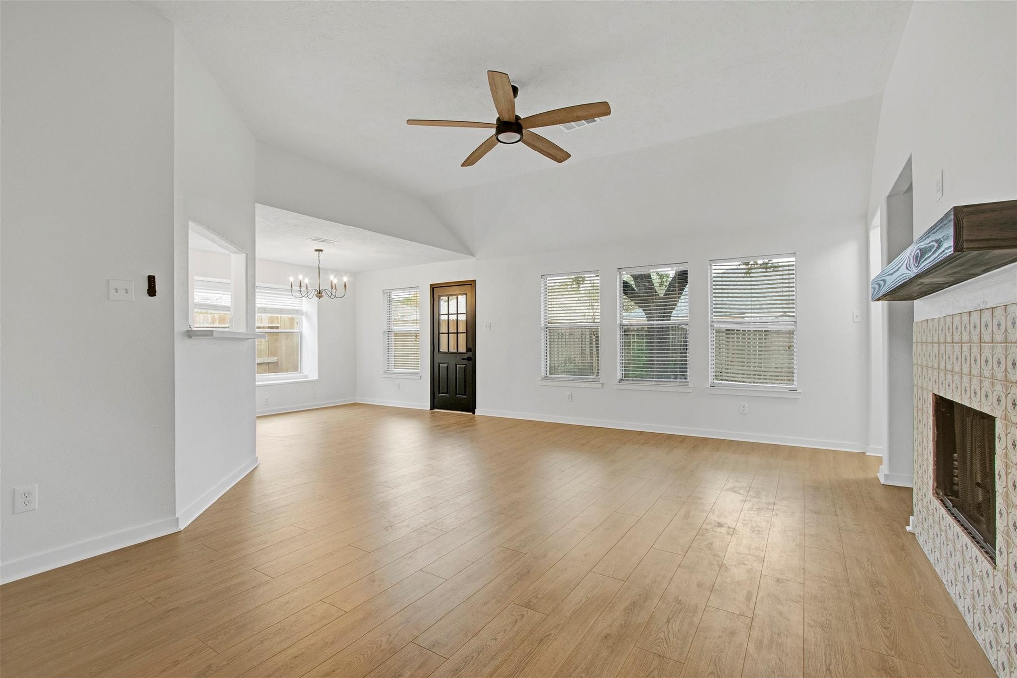 2414 Cres Hollow Court Spring, TX 77388 - Photo 9 of 37 a view of a livingroom with wooden floor a fireplace and windows