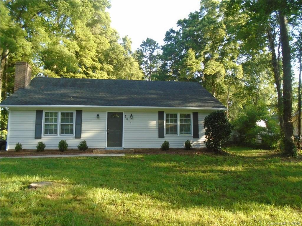 6011 Trotters Ridge Road Charlotte, NC 28227 - Photo 1 of 8 a front view of a house with a garden and trees