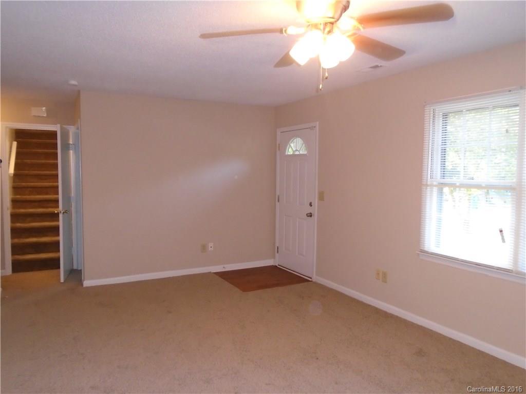 6011 Trotters Ridge Road Charlotte, NC 28227 - Photo 3 of 8 an empty room with a window and a ceiling fan