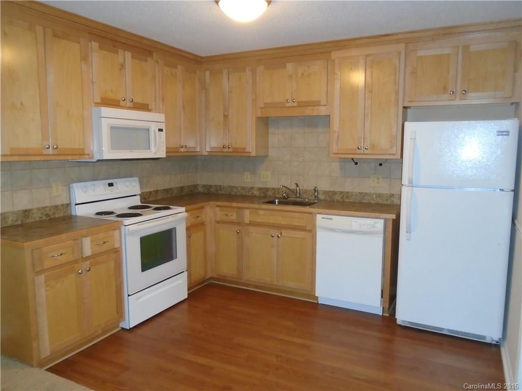 6011 Trotters Ridge Road Charlotte, NC 28227 - Photo 5 of 8 a kitchen with a white cabinets and white appliances
