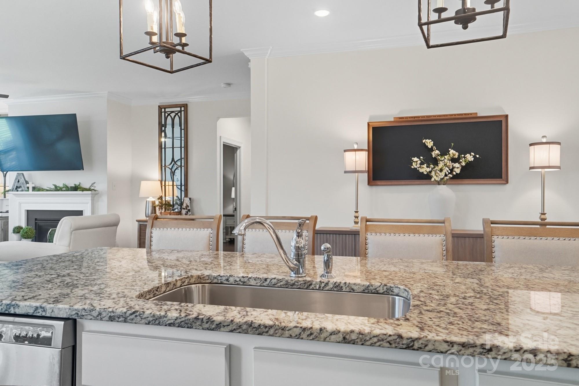 2048 Poplar Ridge Drive Monroe, NC 28110 - Photo 13 of 44 a kitchen with kitchen island granite countertop a sink a counter top space appliances and cabinets