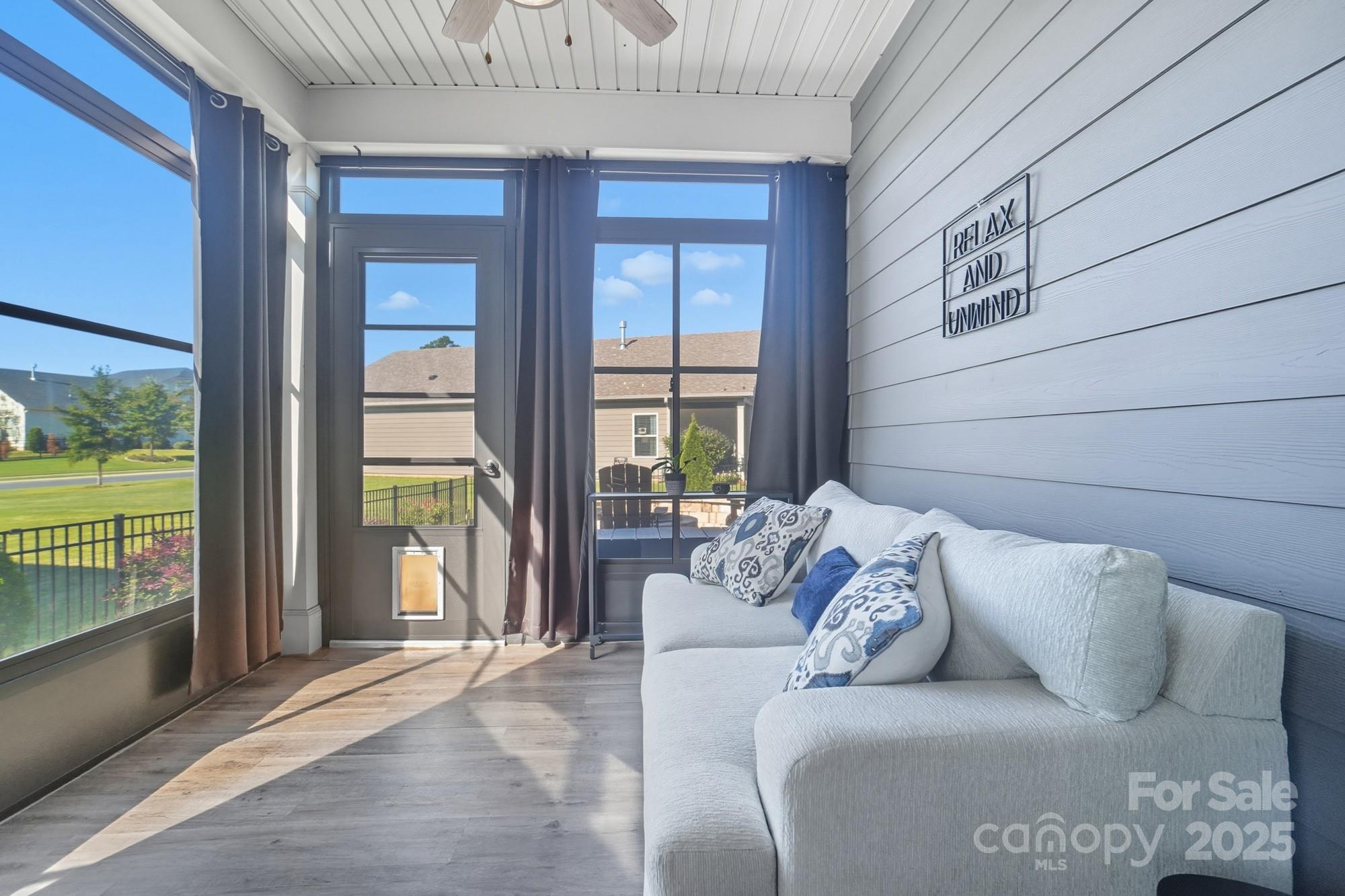 2048 Poplar Ridge Drive Monroe, NC 28110 - Photo 18 of 44 a living room with furniture and a floor to ceiling window
