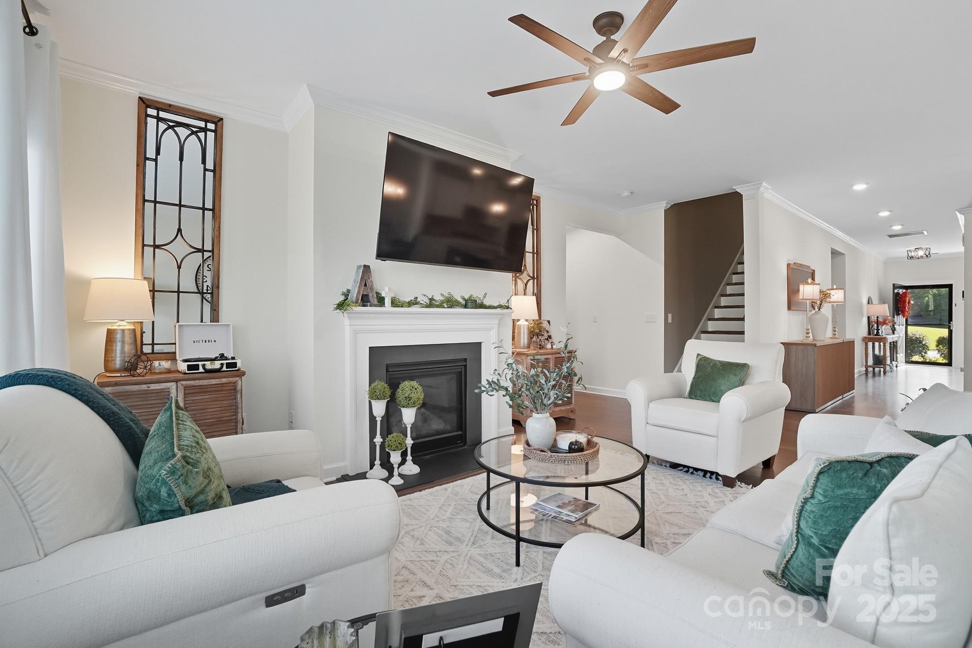 2048 Poplar Ridge Drive Monroe, NC 28110 - Photo 2 of 44 a living room with furniture a flat screen tv and a fireplace