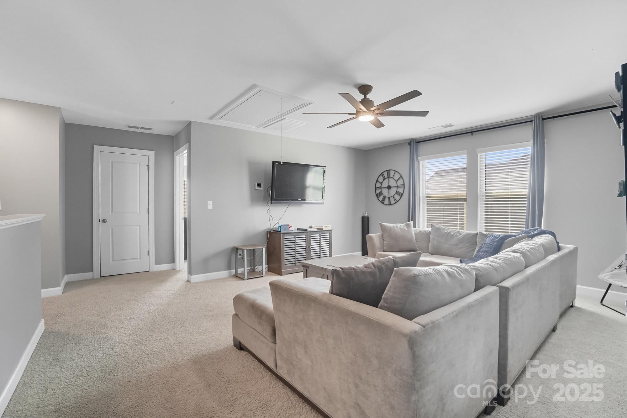 2048 Poplar Ridge Drive Monroe, NC 28110 - Photo 24 of 44 a living room with furniture a ceiling fan and a window