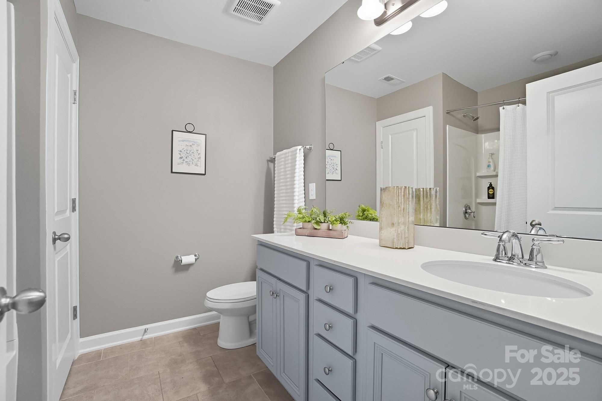 2048 Poplar Ridge Drive Monroe, NC 28110 - Photo 27 of 44 a spacious bathroom with a granite countertop sink a toilet and a mirror